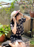 Cropped shirt made from silk linen with black and white floral pattern.